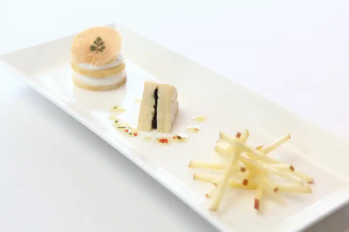 Chef plating a destination tasting menu in a hotel restaurant