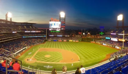 Stadium exterior with grounds crew and tarpaulin ahead of a postseason game