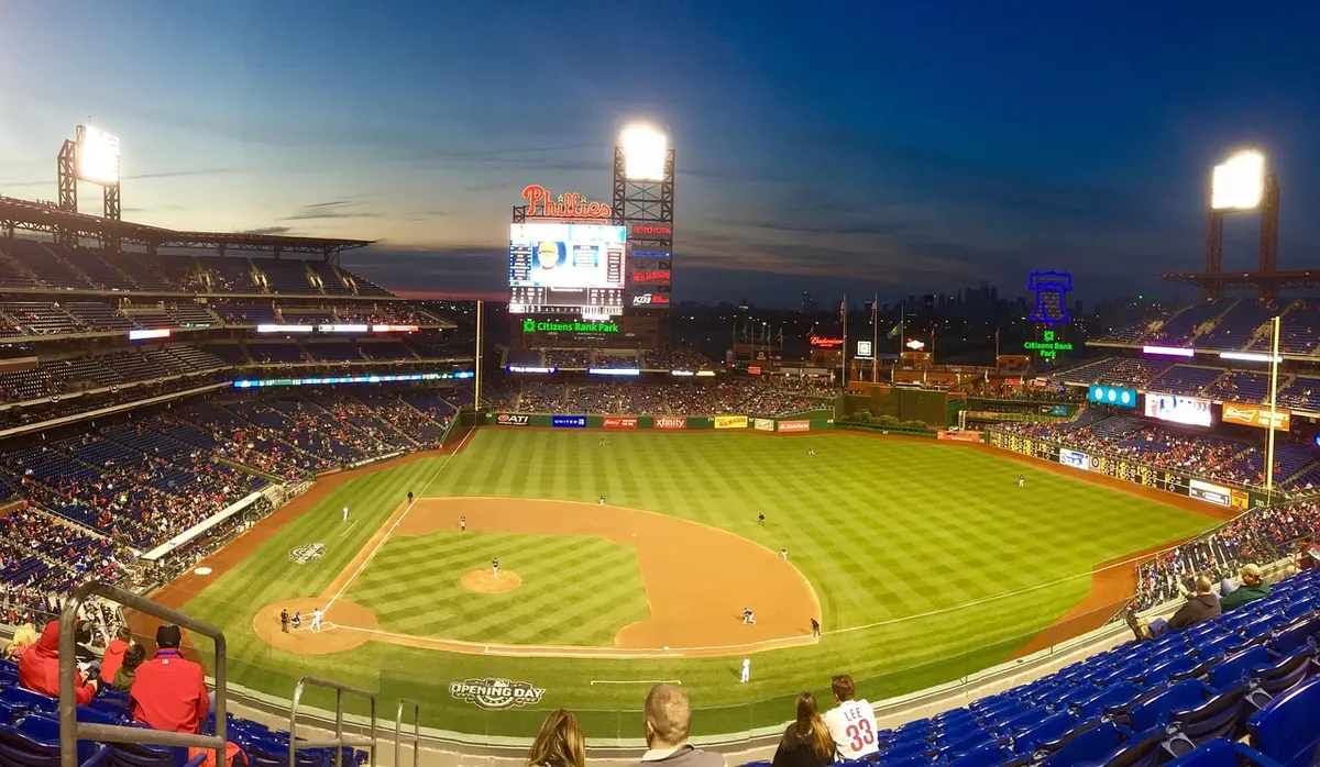 Stadium exterior with grounds crew and tarpaulin ahead of a postseason game