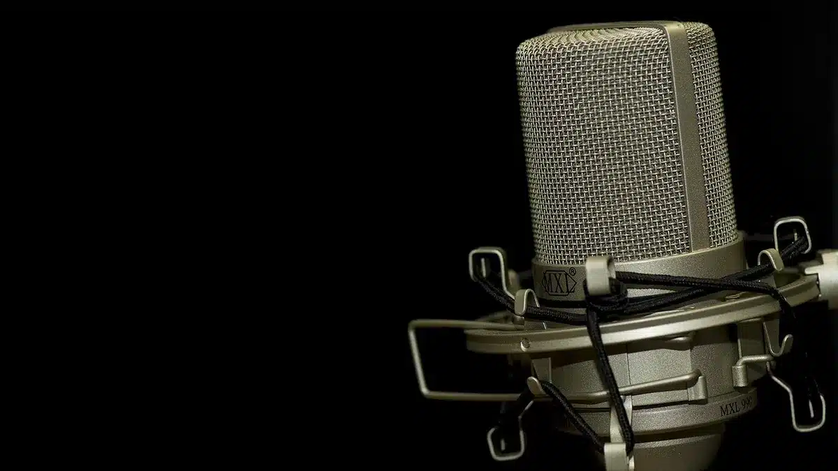 Co-hosts speaking into microphones on a studio set