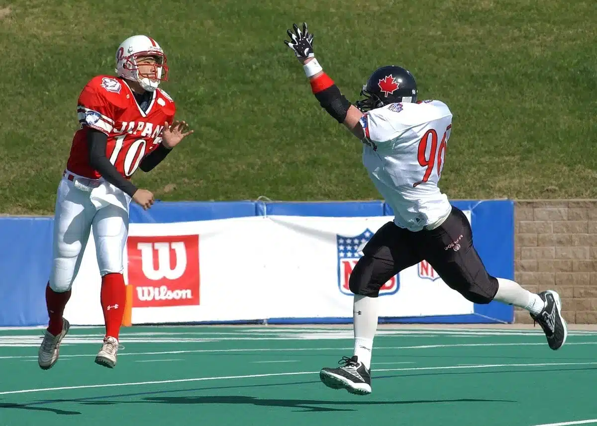 Quarterback releasing a long pass downfield during practice