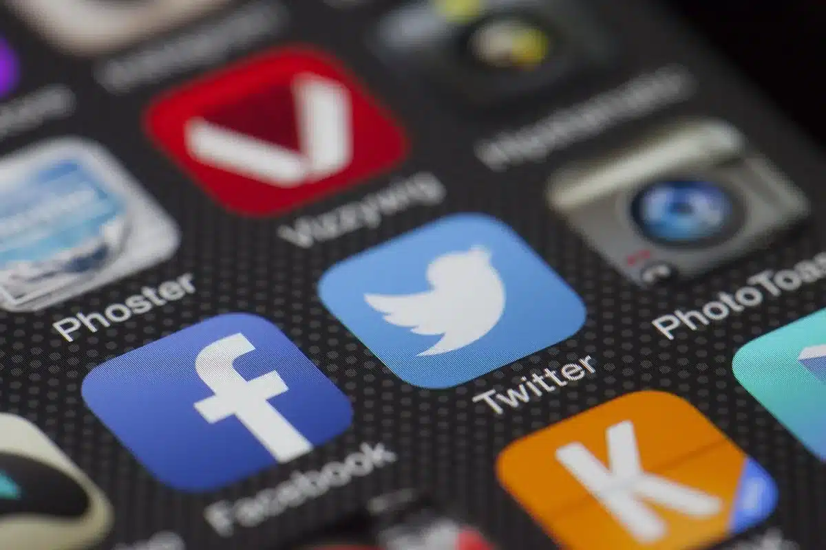 Smartphone screen with social media feeds and reactions about a political dispute