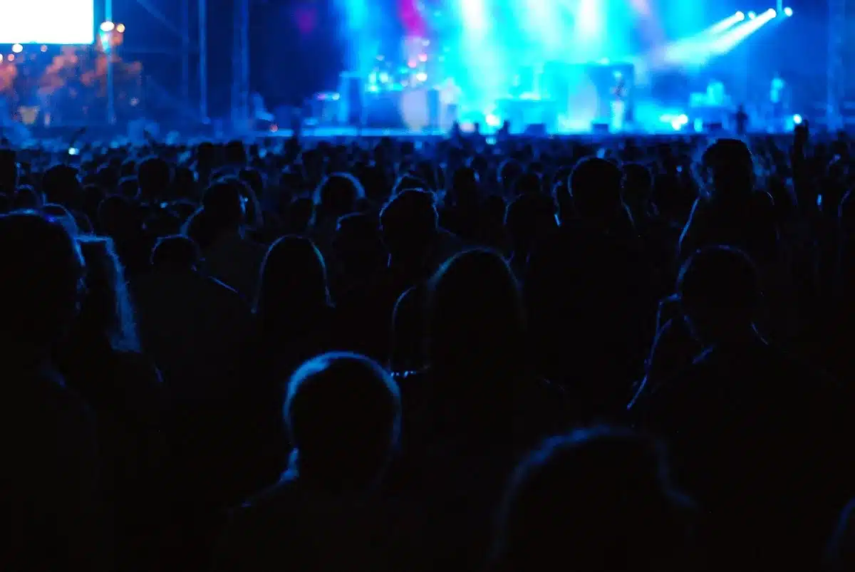 Audience members reacting to a sudden disruption at a political event