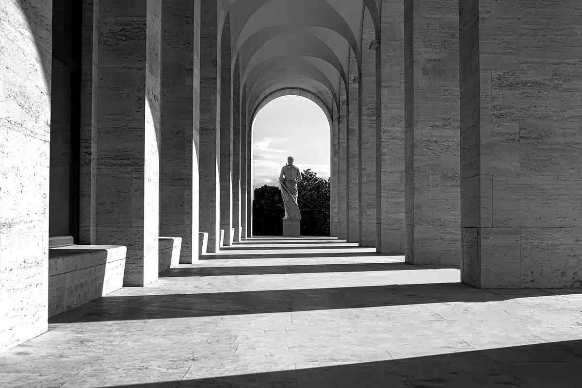 Silhouetted figure whispering in a dim corridor