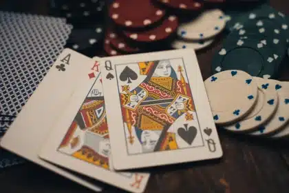 Anonymous hands and cards on a wooden table during tense game-night discussion