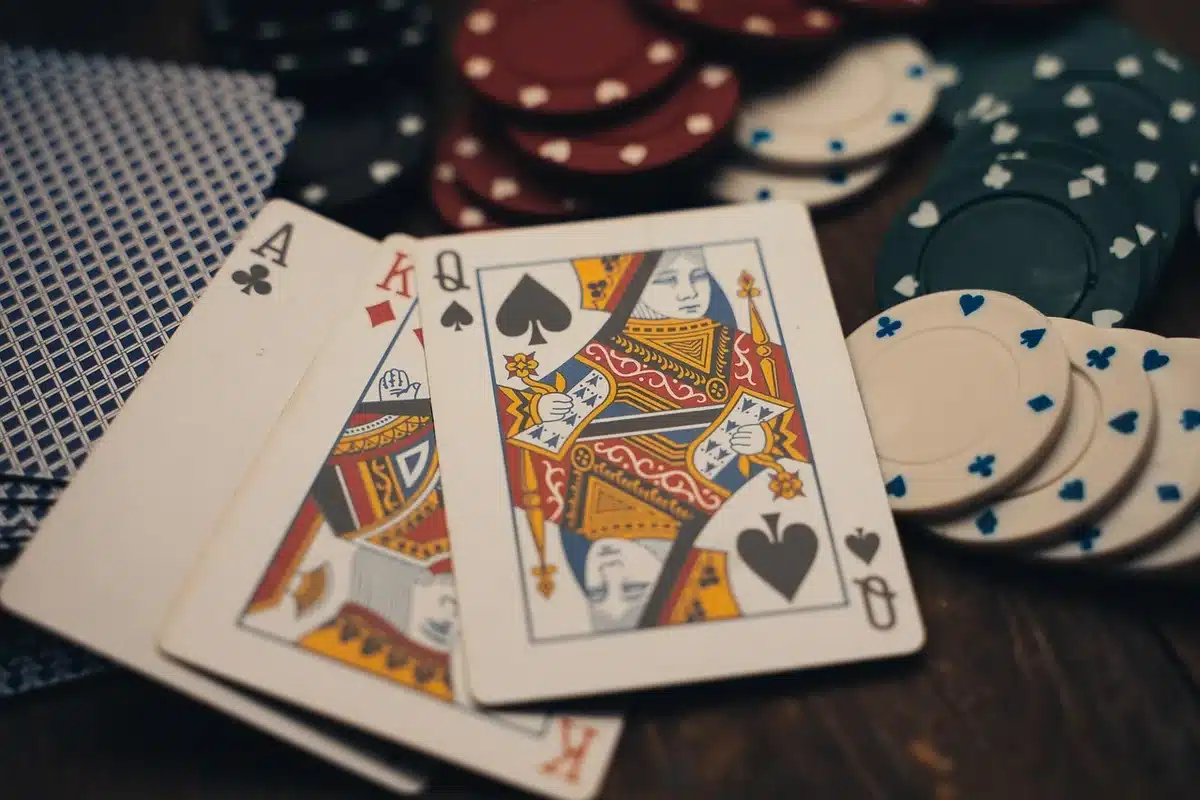 Anonymous hands and cards on a wooden table during tense game-night discussion