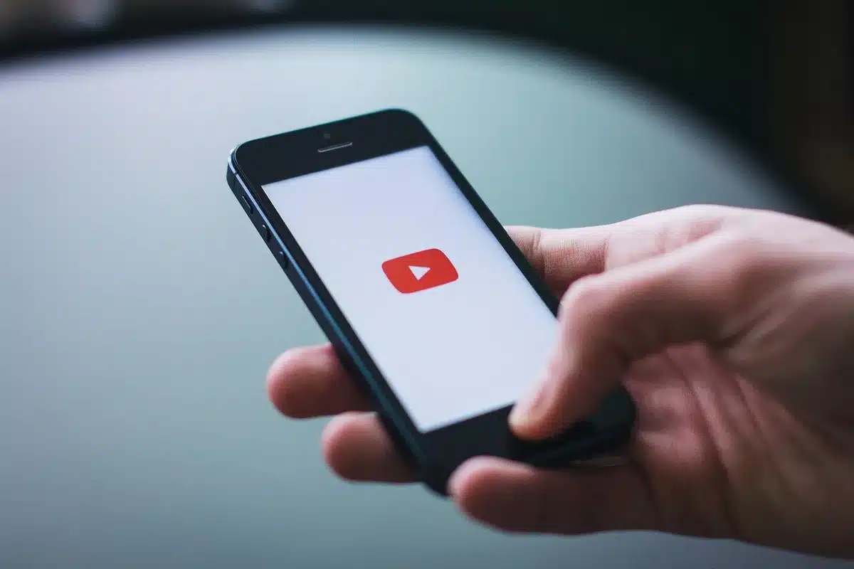 Hands holding phones showing social feeds and comments