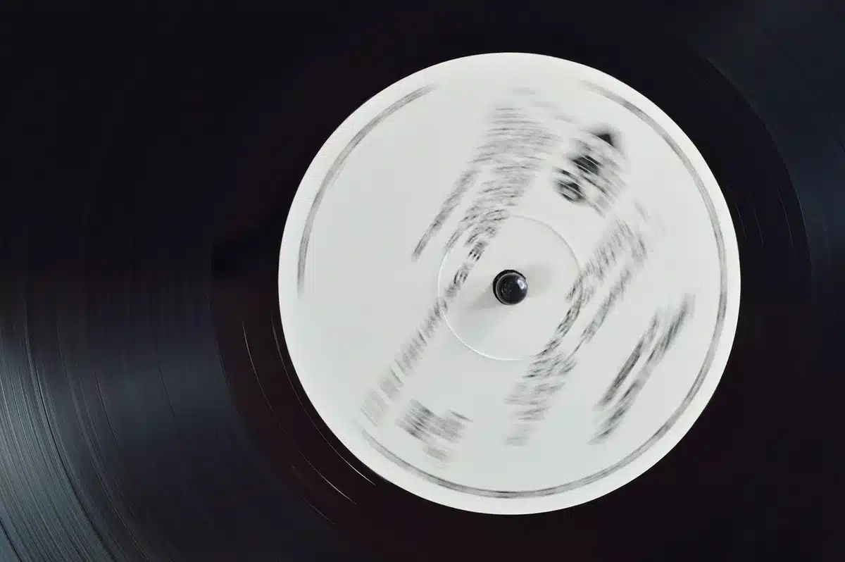 Hands selecting vintage vinyl records in a studio setting