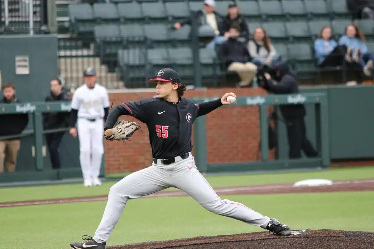 Starting pitcher walking off after being removed, coach nearby
